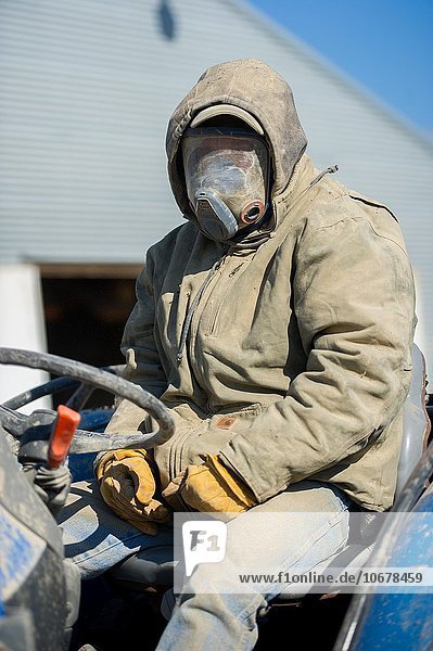 Man wearing protective gear for chicken house clean out in Hurlock  MD. USA.