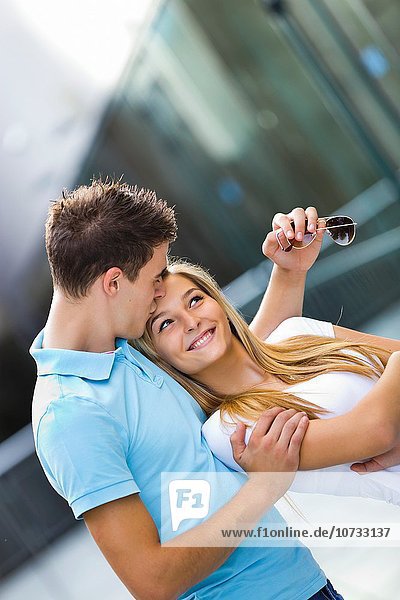 Teen couple girl and boy happy kiss on forehead