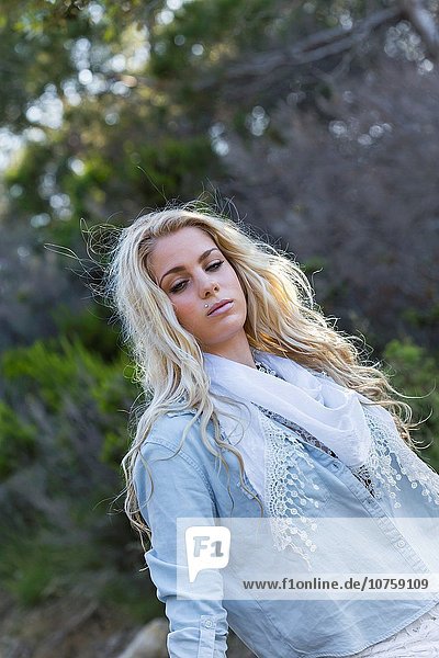Beautiful blonde countrygirl n denim shirt waist-up shot.
