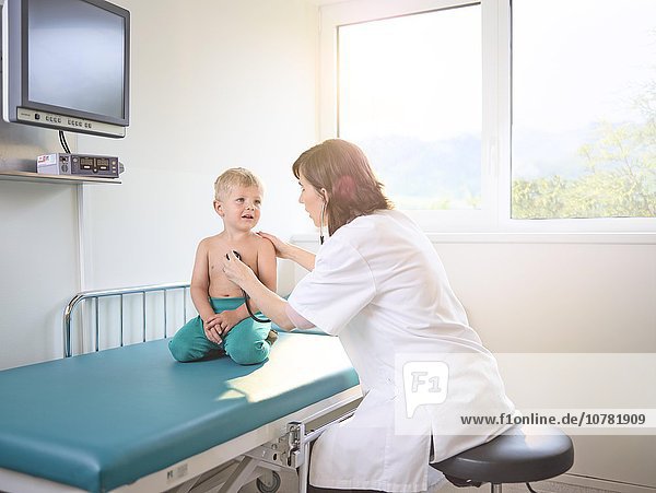 Pediatrician examining boy  3-4 years  blond hair  Austria  Europe