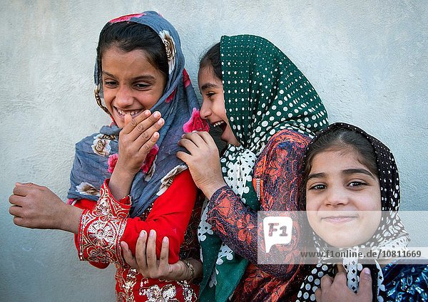 Iran  Qeshm Island  Salakh  little girls laughing in the street.