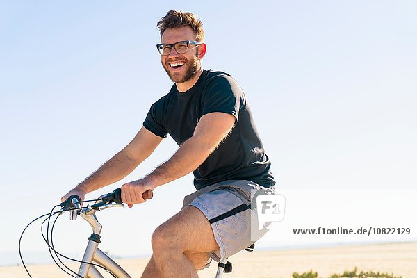 Young man  cycling  smiling