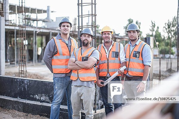 Portrait of site manager and building team on construction site