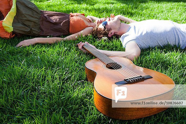 Romantisches junges Paar auf Gartenrasen liegend