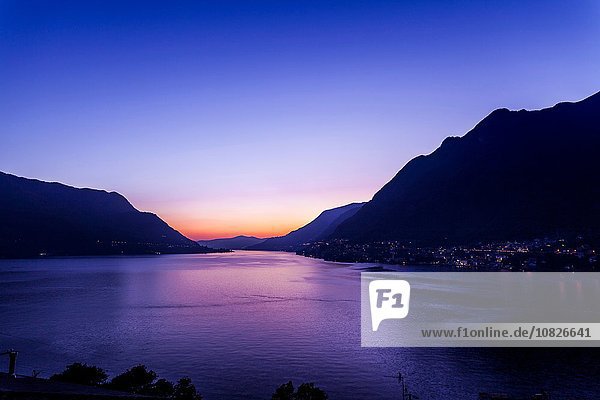 See mit silhouettierten Bergen bei Sonnenuntergang  Pognana Lario  Lombardei  Italien