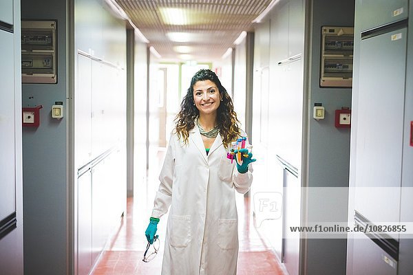 Female scientist walking in laboratory of material science and nanotechnology