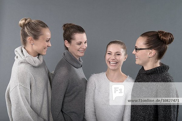Young women smiling  grey background
