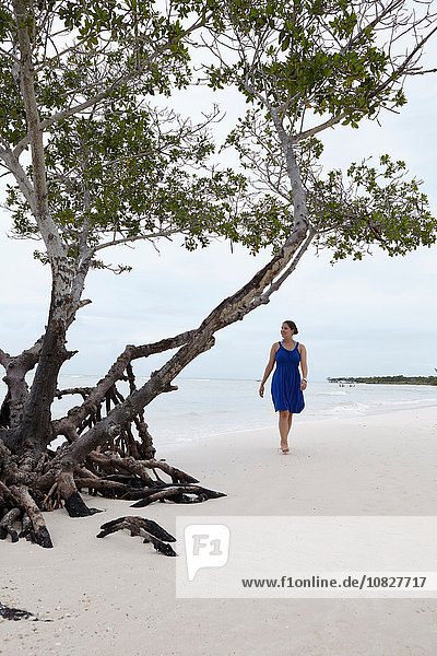 Junge Frau schlendert am Strand entlang,  Kuba
