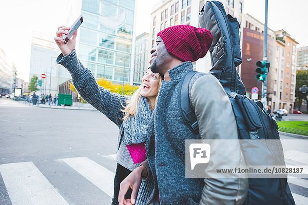 Pärchen nehmen Selfie mit Smartphone auf der Straße