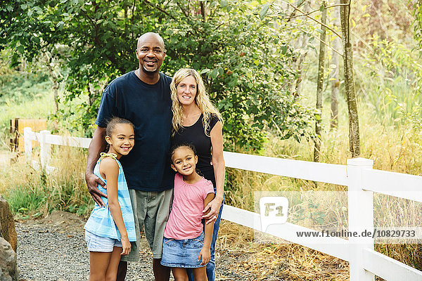 Family smiling on gravel path