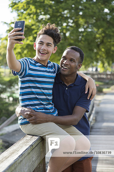 Father and son taking selfie outdoors