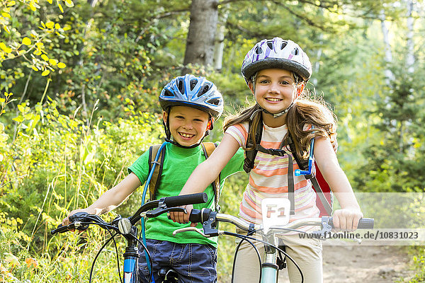 Caucasian children riding mountain bikes