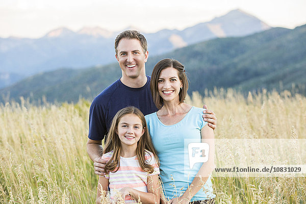 Caucasian family smiling in field