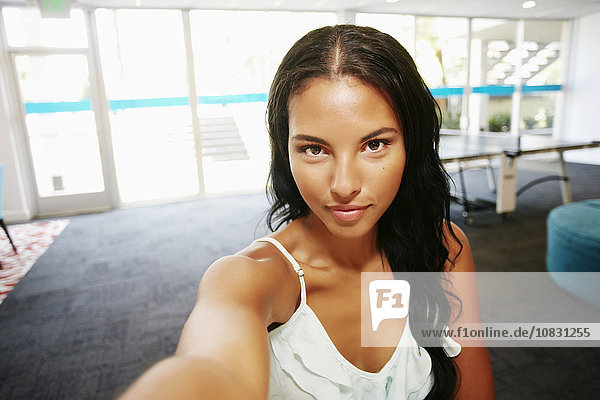 Mixed race woman taking selfie
