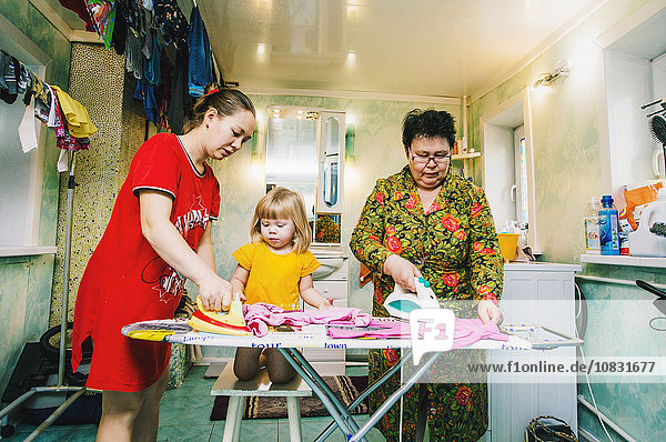 Caucasian women ironing laundry