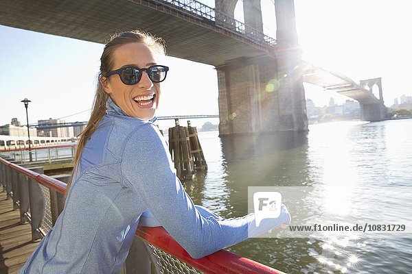 Kaukasische Frau lächelnd am Wasser  New York  New York  Vereinigte Staaten