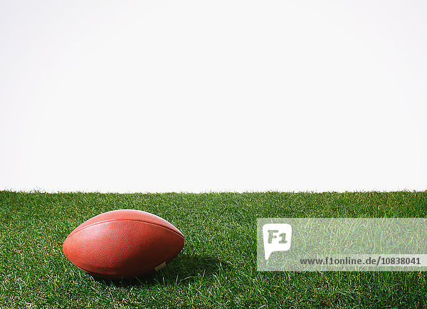American football ball on grass