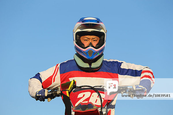 Motocross biker on dirt track