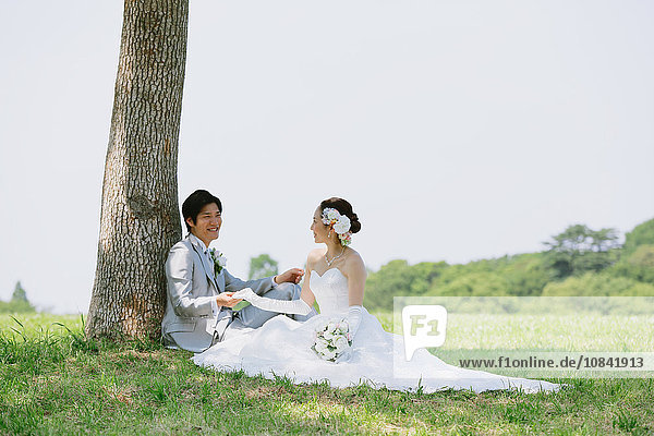 Japanese bride and groom in a city park
