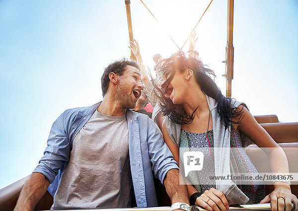 Exhilarated young couple on amusement park ride