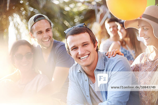 Portrait smiling young man with friends summer outdoors