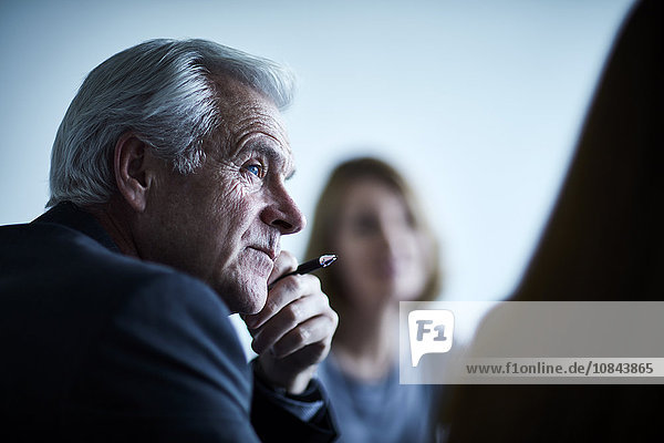 Attentive senior businessman listening in meeting