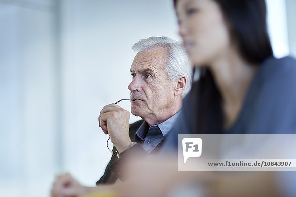 Focused senior businessman listening in meeting