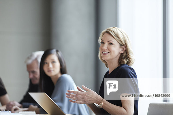 Businesswoman gesturing and talking in meeting