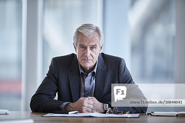 Portrait serious senior businessman in conference room