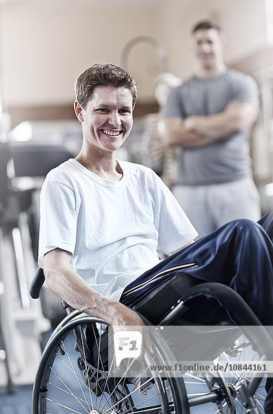 Portrait smiling man in wheelchair at physical therapy office