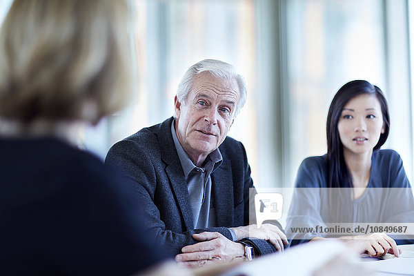 Senior businessman listening in meeting
