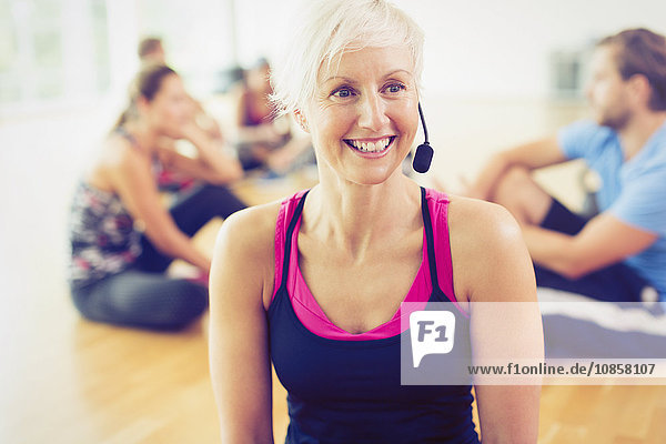 Smiling fitness instructor wearing headset