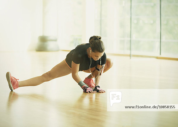 Woman stretching leg in gym studio