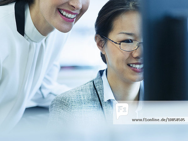 Smiling businesswomen working at computer in office