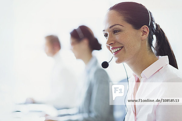 Smiling businesswoman talking on the phone with headset