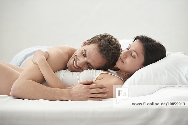 Young couple lying in bed
