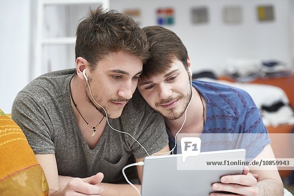 Homosexual couple with tablet