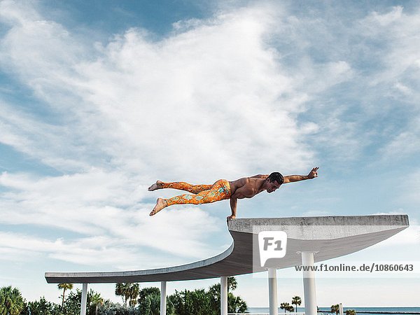 Mature man balancing on structure South Pointe Park South Beach Miami Florida USA
