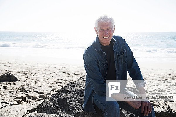 Portrait of senior man on beach  smiling