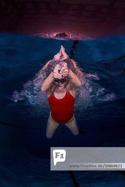 Young woman swimming underwater