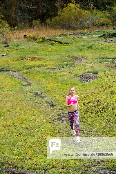 High angle view of teenage female runner running in park