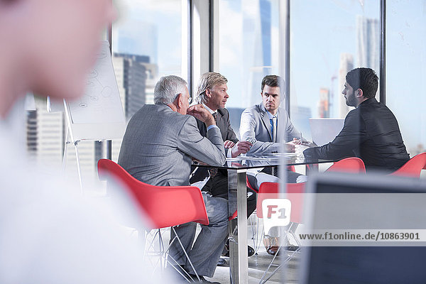 Over shoulder view of businessmen meeting at conference table  New York  USA