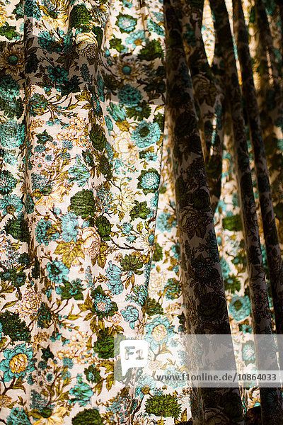 Floral curtains drawn closed on sunny day