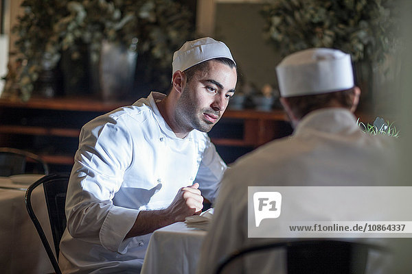 Chefs chatting in restaurant