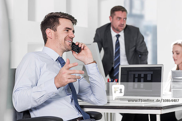 Businessman and businesswoman working  colleague on phone in office