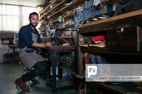 Portrait of male cobbler in traditional shoe workshop