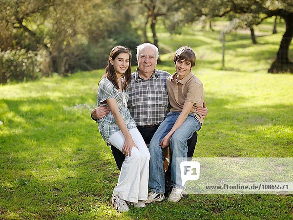 Grand dad with children in countryside