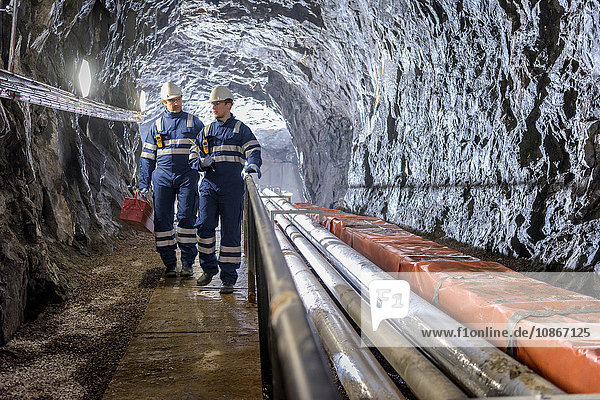 Workers in tunnel in hydroelectric power station