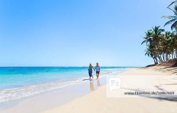 Mature couple strolling along beach  Dominican Republic  The Caribbean