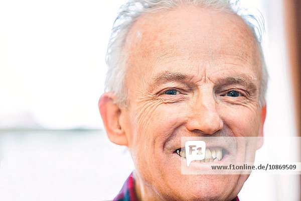 Head shot portrait of happy senior man